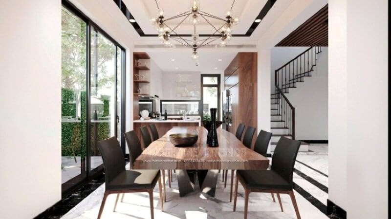 Để tạo nên vẻ đẹp tổng thể trong ý tưởng thiết kế nội thất phòng ăn biệt thự Vinhomes Imperia Hải Phòng, việc sử dụng và trang trí vật liệu lát nền lại càng được chú ý. Sử dụng chút nghệ thuật sắp đặt như trong ý tưởng bố trí trên đây, đá lát nền được bao bọc xung quanh bởi khung viền đá đen như thể hiện ranh giới rõ ràng của phòng ăn, phóng tầm mắt lên trên, bạn có thể thấy vẻ đẹp này được thể hiện đồng bộ khi trần thạch cao được tô điểm thêm đường viền vuông vắn phối cùng đèn âm tường tạo vẻ đẹp độc đáo cho không gian bếp.